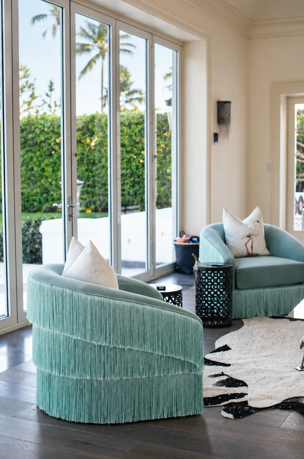 Indian Creek Residence — Garden room with fringed aqua swivel chairs